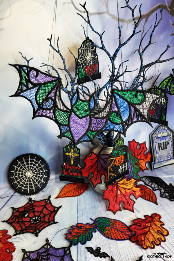 Halloween tree decorations including bats tombs and cobwebs