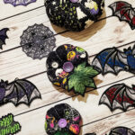 Halloween decorations including pumpkins, bats and cobweb doilies.