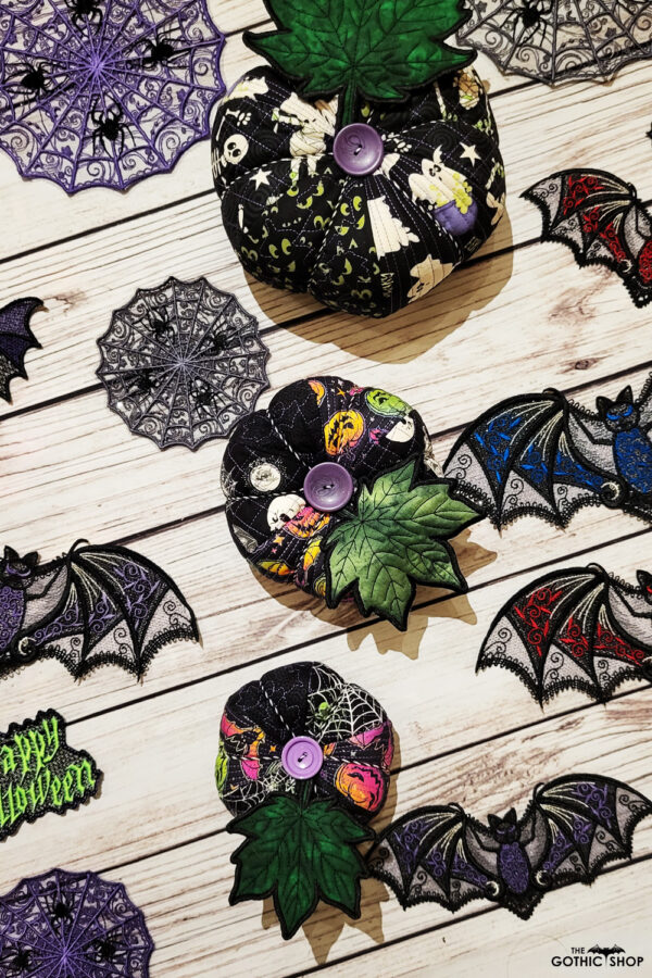 Halloween decorations including pumpkins, bats and cobweb doilies.