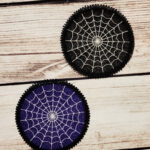 Purple and black lace coasters with white cobweb