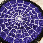 Purple lace coaster with white cobweb