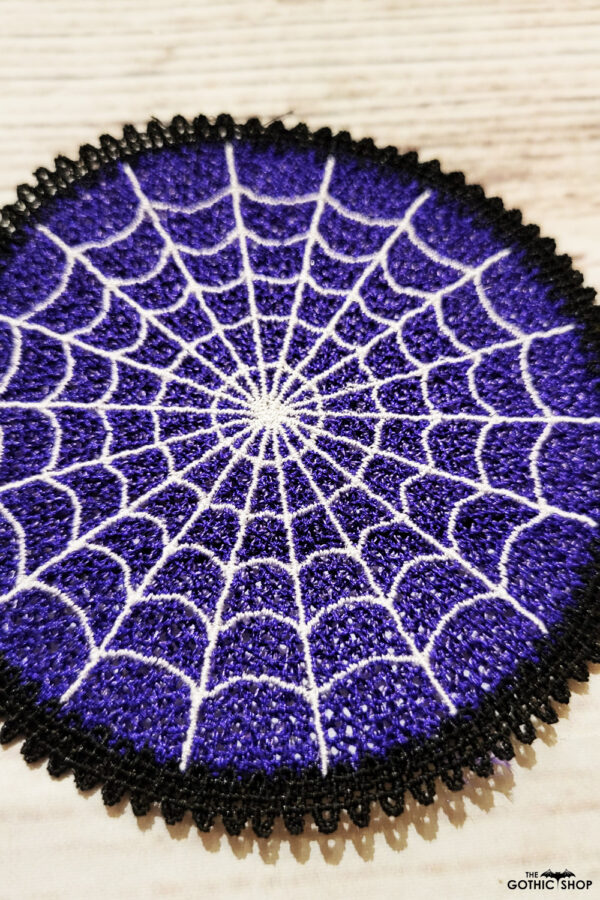 Purple lace coaster with white cobweb