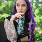 Gothic model VenusMantrap with our trippy mushroom tumbler and bats and cobwebs tumbler.