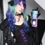 Goth model Valentinescorpse wears the Dark in Love Oriana Purple Velvet Black Lace Gothic Lolita Mini Dress. She holds the Cat Ghost tumbler.