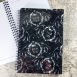 You Goth This winged cameo bats on a dark background detailed with webs and stars
