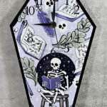 Skeleton Reading Lilac Purple Coffin Shaped Metal Gothic Clock