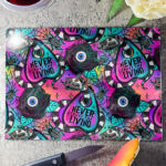never trust the living sandworm & planchette gothic glass chopping board