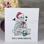 Spooky Skeleton with Gift Gothic Christmas Card