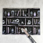 bookish witchy curios rustic grungy grey bookshelves glass chopping board or worktop protector