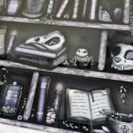 bookish witchy curios rustic grungy grey bookshelves glass chopping board or worktop protector
